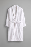 A white cotton bathrobe with a shawl collar, tie belt