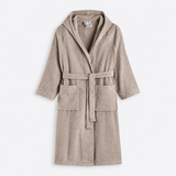 A hooded bathrobe in a soft taupe-beige terry cloth, featuring a matching waist tie belt and two front patch pockets, shown against a plain white background.